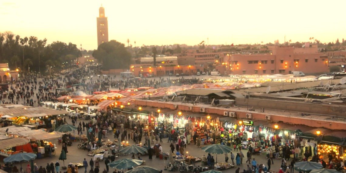 Jemaa el-Fna square and the Koutoubia minaret in Marrakech at dusk